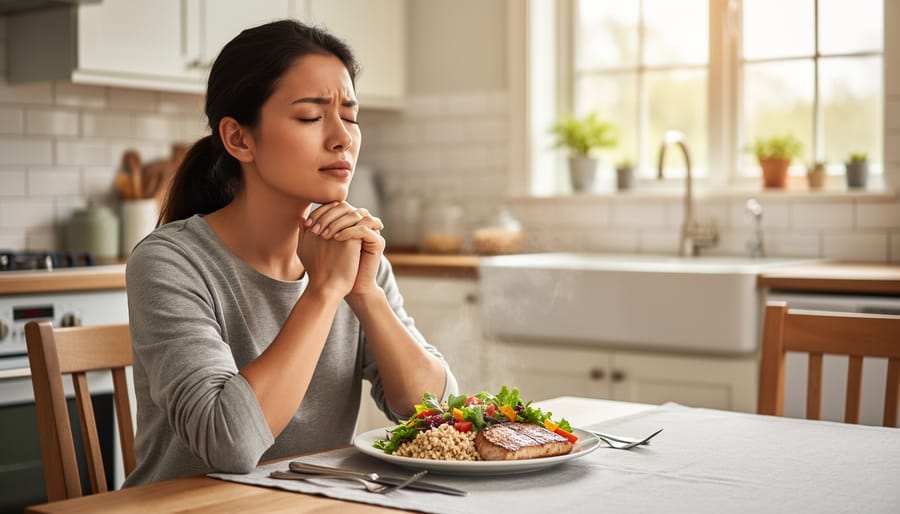Woman peacefully pausing with eyes closed before eating a healthy meal at dining table
